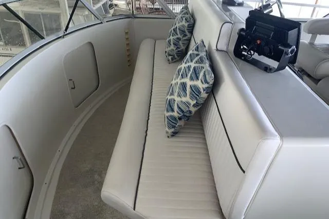 Slide: The Image of 1995 Carver 370 Aft Cabin interior with cushioned seating and patterned pillows. - 9