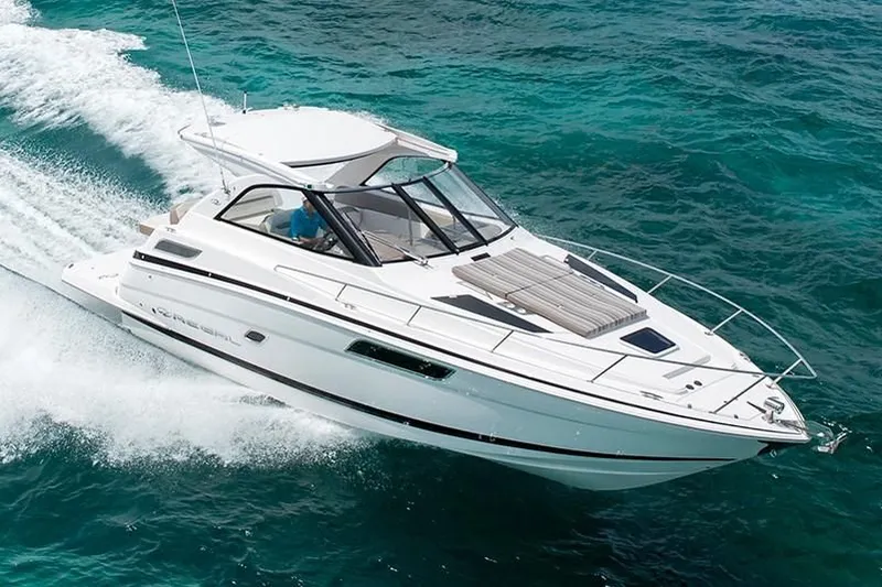 Slide: The Image of 2019 Regal 35 Sport Coupe cruising on clear blue water. - 33