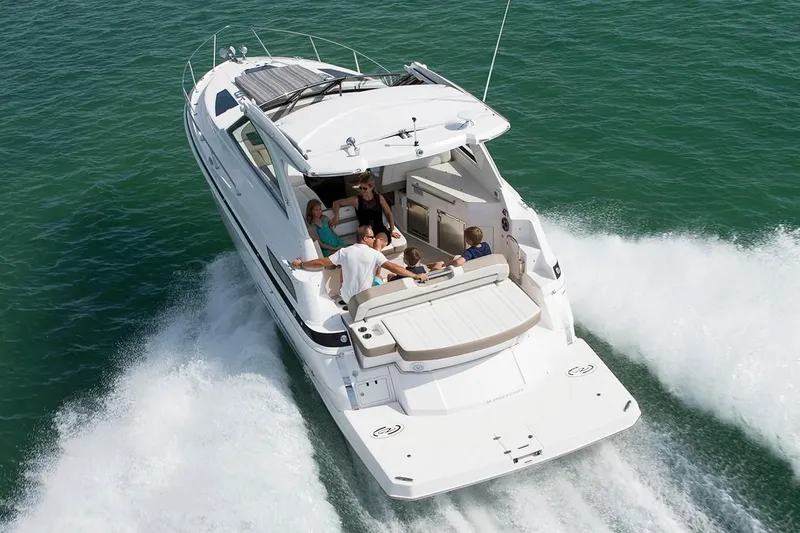 Slide: The Image of 2019 Regal 35 Sport Coupe cruising with passengers on open water. - 37