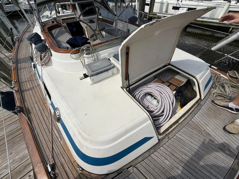 Slide: The Image of Sailboat deck of 1999 Bavaria 42 Ocean with open storage compartment. - 17