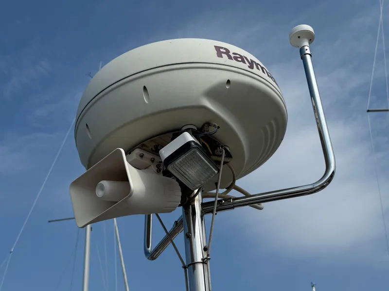 Slide: The Image of Radar and communication equipment on a 1999 Bavaria 42 Ocean sailboat under a clear sky. - 18