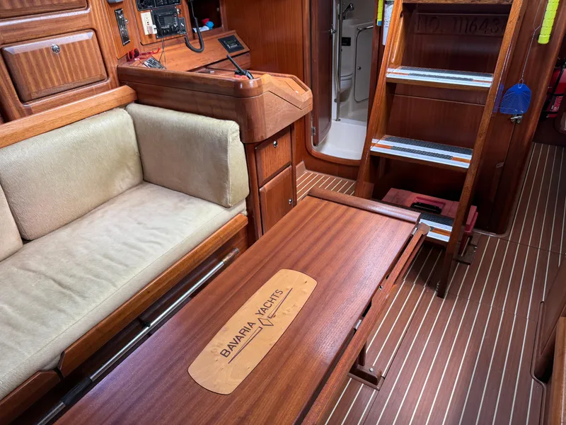 Slide: The Image of Interior of 1999 Bavaria 42 Ocean yacht with wooden furnishings and cozy seating. - 22