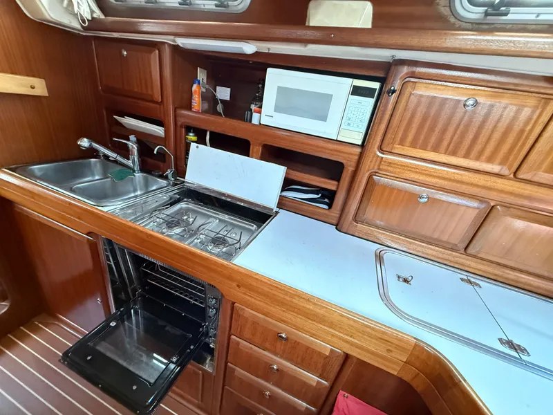 Slide: The Image of Interior of 1999 Bavaria 42 Ocean yacht kitchen with stove, sink, and microwave. - 33