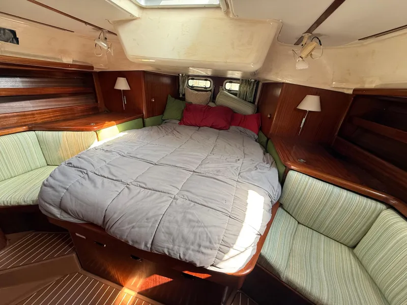 Slide: The Image of Cozy cabin interior of 1999 Bavaria 42 Ocean yacht with double bed and wooden furnishings. - 34
