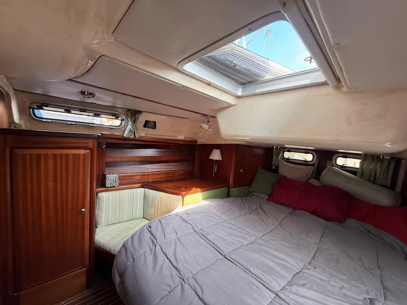 Slide: The Image of Cozy cabin interior of 1999 Bavaria 42 Ocean yacht with skylight and wooden furnishings. - 35
