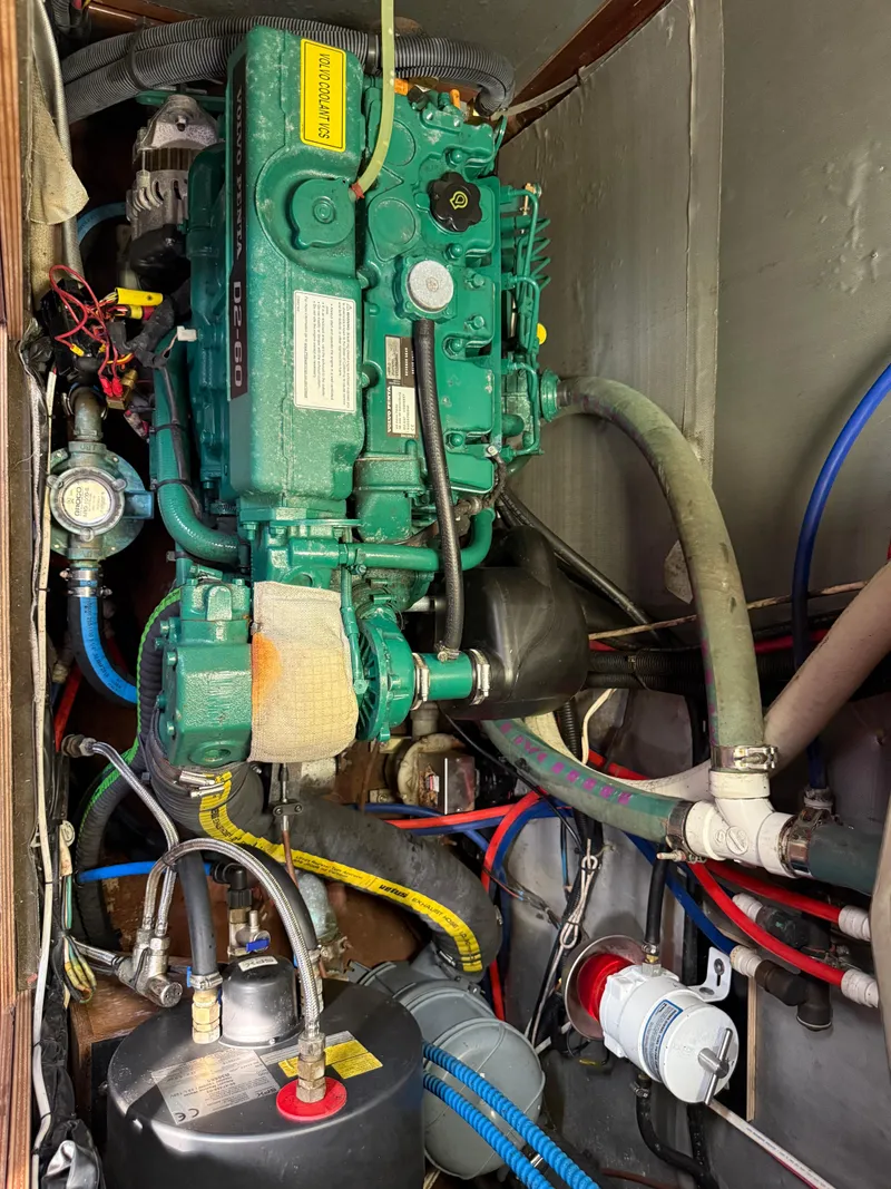 Slide: The Image of Engine compartment of a 1999 Bavaria 42 Ocean sailboat, showcasing detailed mechanical components. - 39