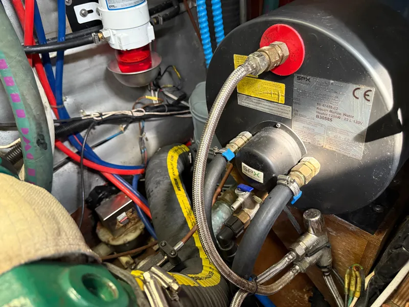 Slide: The Image of Engine room of a 1999 Bavaria 42 Ocean yacht with marine equipment and wiring. - 42