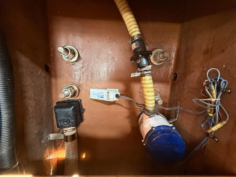 Slide: The Image of Bilge area of 1999 Bavaria 42 Ocean yacht with hoses and wiring. - 43