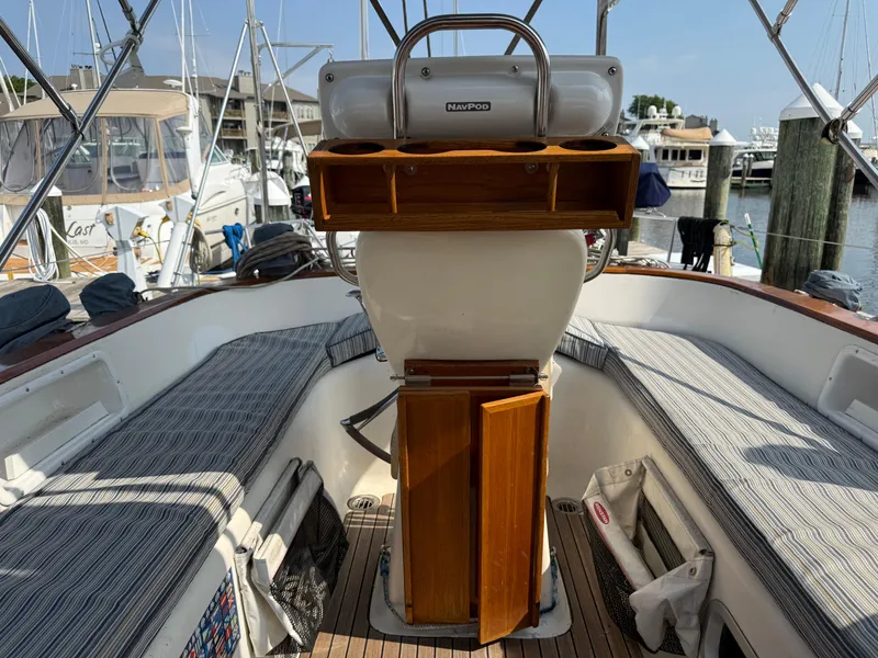 Slide: The Image of Cockpit of 1999 Bavaria 42 Ocean sailboat with striped seating and wooden helm station. - 5