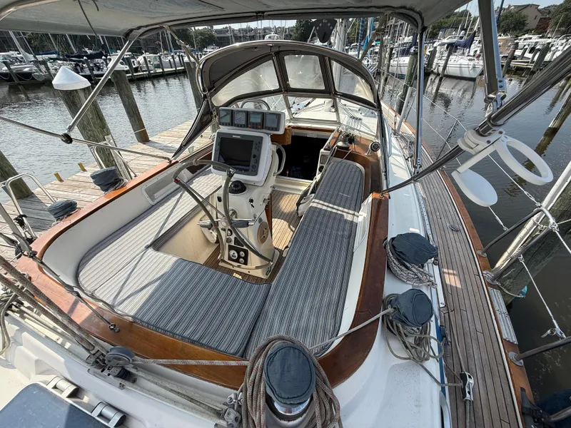 Slide: The Image of Cockpit of 1999 Bavaria 42 Ocean sailboat docked at marina, featuring navigation equipment. - 7