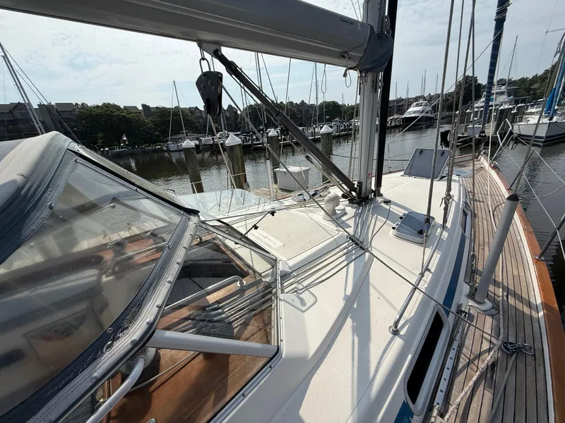 Slide: The Image of 1999 Bavaria 42 Ocean sailboat docked at a marina, showcasing deck and rigging. - 8