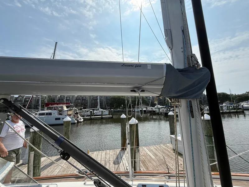 Slide: The Image of Sailboat Bavaria 42 Ocean, 1999 model, docked at marina with clear sky. - 9