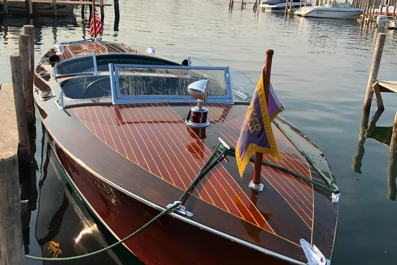 Slide: The Image of Vintage 1931 Hacker-Craft 26 Dolphin boat docked on calm water. - 1