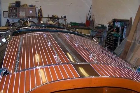 Slide: The Image of 1931 Hacker-Craft 26 Dolphin boat with polished wooden deck in a workshop. - 106