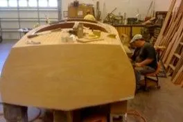 Slide: The Image of 1931 Hacker-Craft 26 Dolphin boat under restoration in workshop setting. - 119