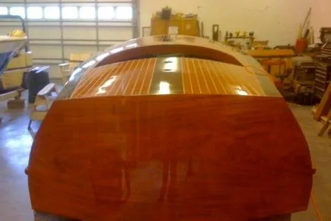 Slide: The Image of Restored 1931 Hacker-Craft 26 Dolphin boat in a workshop setting. - 138