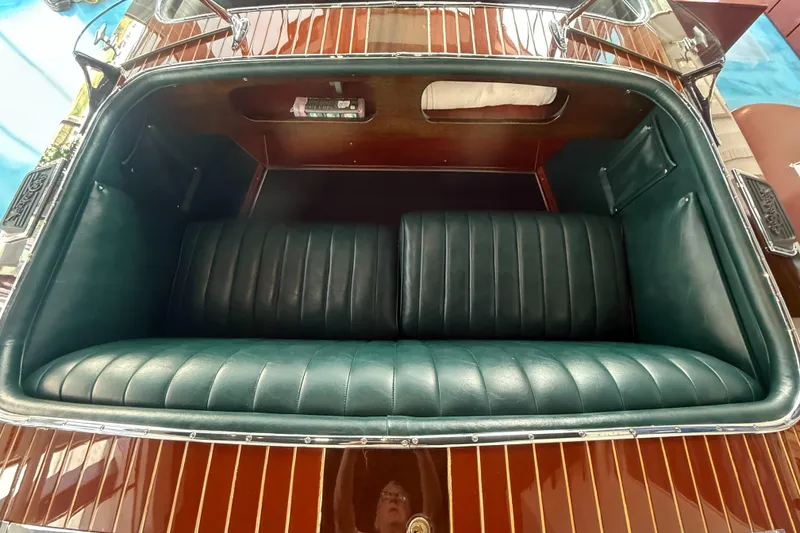 Slide: The Image of Interior of a 1931 Hacker-Craft 26 Dolphin boat with green leather seating. - 14