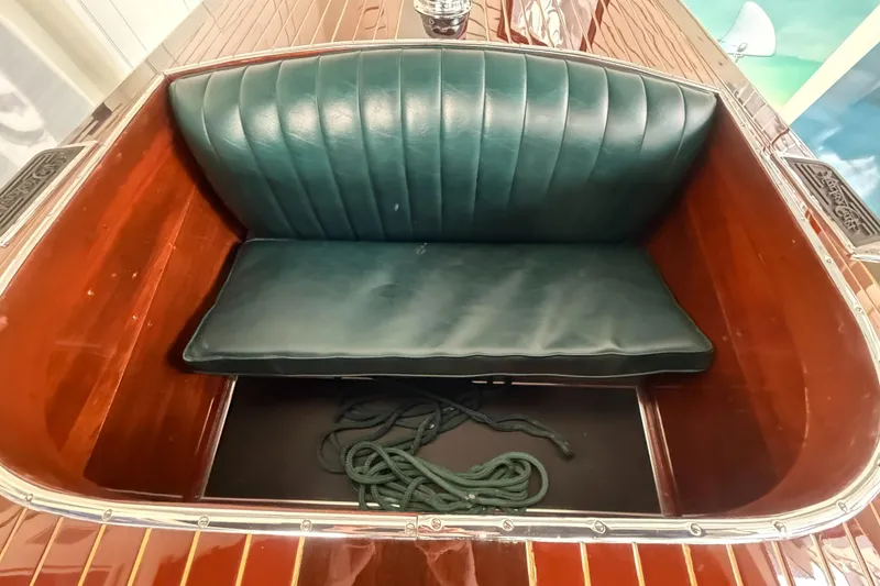 Slide: The Image of Luxurious 1931 Hacker-Craft 26 Dolphin boat interior with green leather seat and wooden finish. - 16