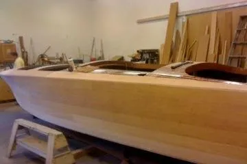 Slide: The Image of 1931 Hacker-Craft 26 Dolphin boat under restoration in a workshop setting. - 161