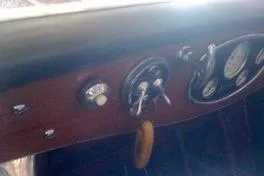 Slide: The Image of Dashboard of a 1931 Hacker-Craft 26 Dolphin boat with vintage gauges and controls. - 166