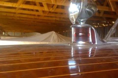 Slide: The Image of 1931 Hacker-Craft 26 Dolphin with polished wood finish in a wooden boathouse. - 169