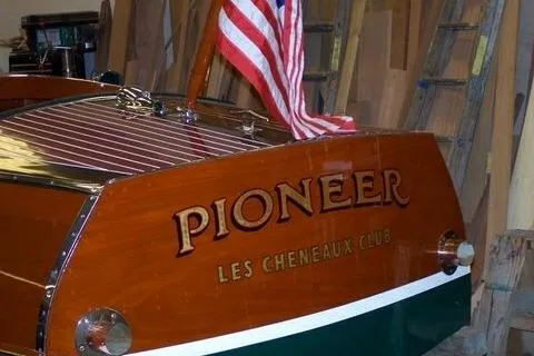 Slide: The Image of 1931 Hacker-Craft 26 Dolphin boat with "Pioneer" name and American flag, Les Cheneaux Club. - 170