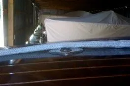 Slide: The Image of 1931 Hacker-Craft 26 Dolphin boat in storage, partially covered. - 179