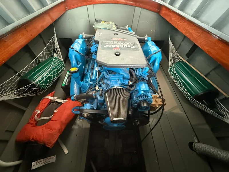 Slide: The Image of Engine of a 1931 Hacker-Craft 26 Dolphin boat, featuring a blue Crusader engine. - 19