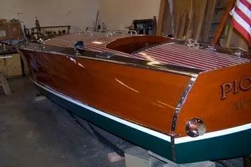 Slide: The Image of 1931 Hacker-Craft 26 Dolphin boat with polished wood finish and American flag. - 193