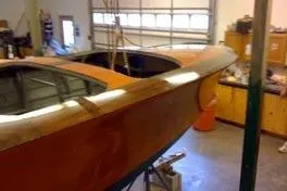 Slide: The Image of 1931 Hacker-Craft 26 Dolphin boat in a garage workshop setting. - 200