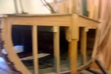 Slide: The Image of 1931 Hacker-Craft 26 Dolphin boat under restoration, showcasing wooden frame structure. - 201