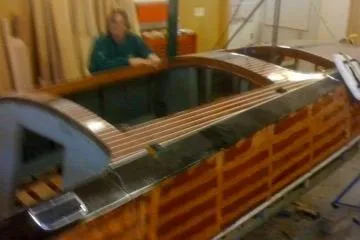 Slide: The Image of 1931 Hacker-Craft 26 Dolphin boat under restoration in workshop setting. - 202