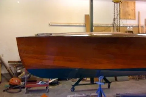 Slide: The Image of 1931 Hacker-Craft 26 Dolphin boat in workshop, showcasing classic wooden design. - 205
