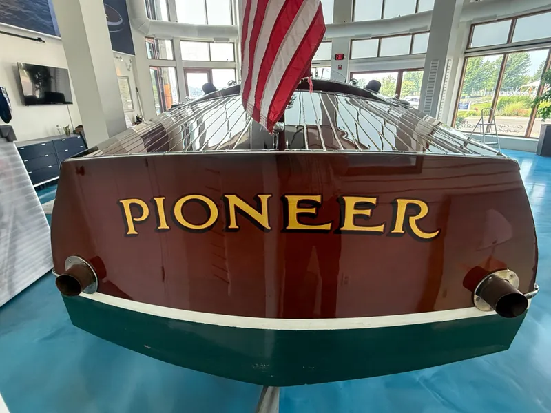 Slide: The Image of Vintage 1931 Hacker-Craft 26 Dolphin boat named "Pioneer" displayed indoors. - 21