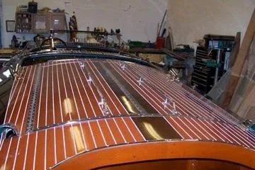 Slide: The Image of Restored 1931 Hacker-Craft 26 Dolphin boat with polished wooden deck in workshop. - 214