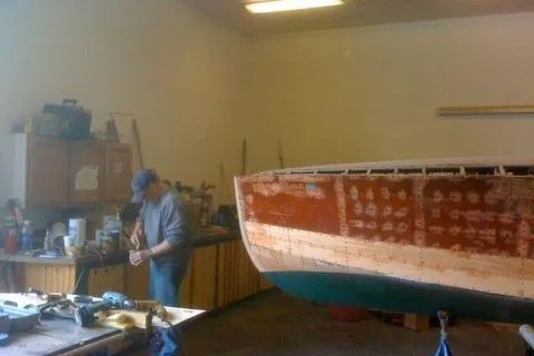 Slide: The Image of Man working on 1931 Hacker-Craft 26 Dolphin boat restoration in workshop. - 242