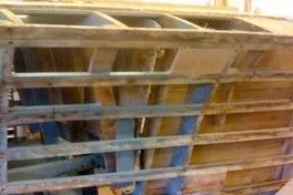 Slide: The Image of 1931 Hacker-Craft 26 Dolphin boat under restoration, showcasing wooden frame and structure. - 244