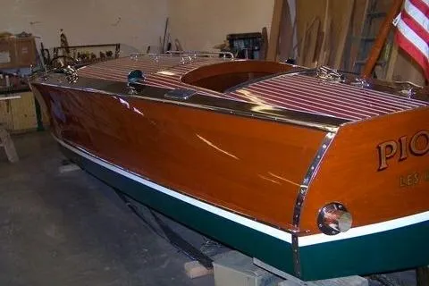 Slide: The Image of 1931 Hacker-Craft 26 Dolphin wooden boat with polished finish in a workshop setting. - 249
