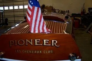 Slide: The Image of 1931 Hacker-Craft 26 Dolphin boat with American flag, "Pioneer" and "Les Cheneaux Club" inscriptions. - 29