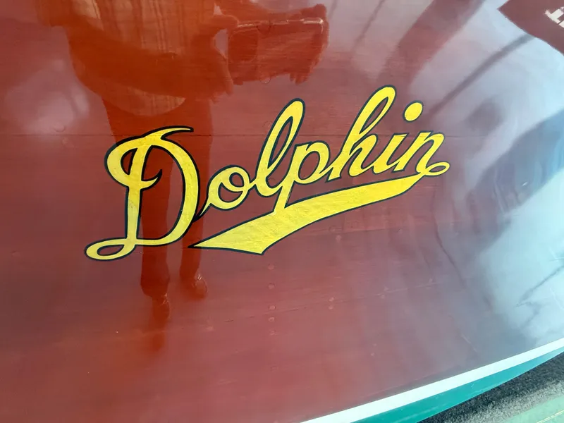 Slide: The Image of 1931 Hacker-Craft 26 Dolphin logo on polished wooden surface. - 6