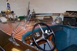 Slide: The Image of 1931 Hacker-Craft 26 Dolphin boat interior with wooden dashboard and steering wheel. - 68
