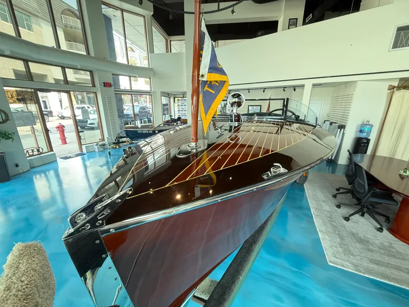 Slide: The Image of 1931 Hacker-Craft 26 Dolphin boat displayed indoors with polished wood finish. - 7