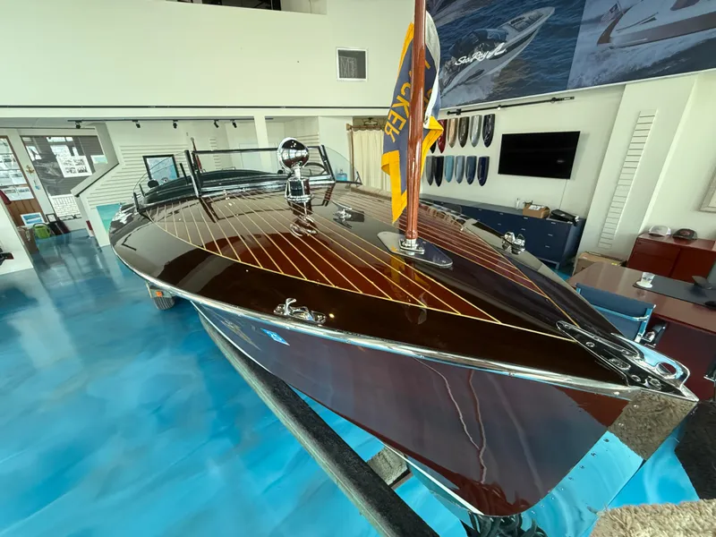 Slide: The Image of 1931 Hacker-Craft 26 Dolphin boat with polished wood finish in showroom. - 8