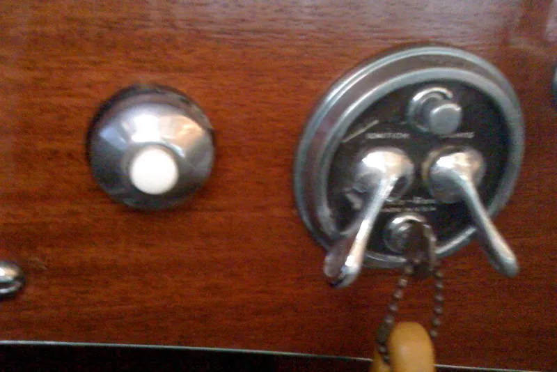 Slide: The Image of Dashboard controls of a 1931 Hacker-Craft 26 Dolphin boat, featuring vintage switches. - 80