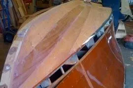 Slide: The Image of 1931 Hacker-Craft 26 Dolphin boat under restoration, showcasing wooden hull details. - 89