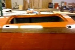 Slide: The Image of 1931 Hacker-Craft 26 Dolphin boat with wooden finish in workshop setting. - 94