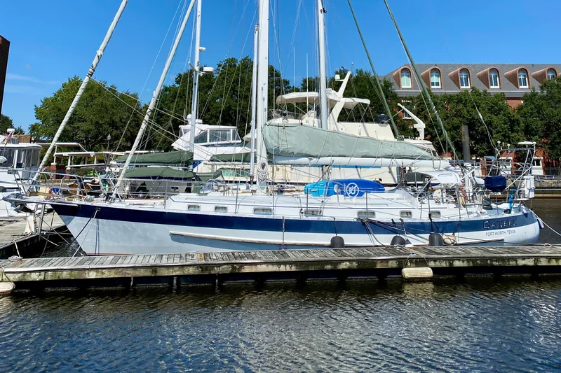 The Image of 2007 Valiant 50 sailboat docked at marina, clear blue sky background. - 0