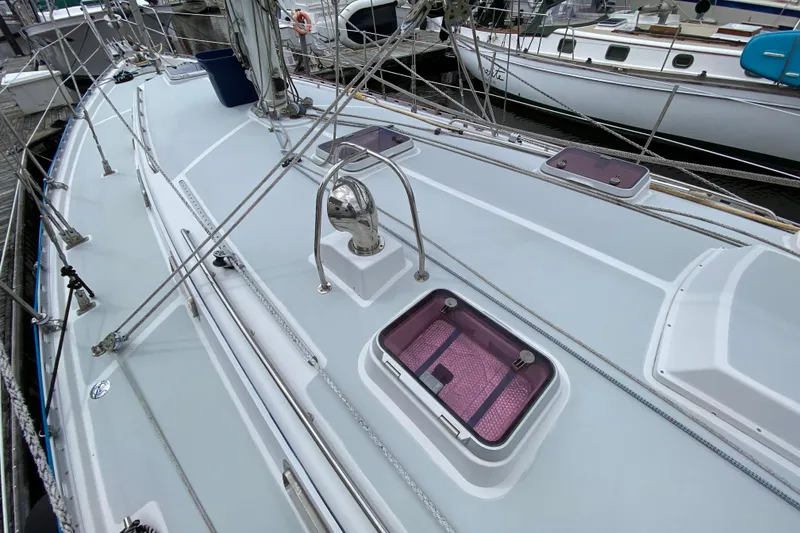 Slide: The Image of 2007 Valiant 50 sailboat deck with winches, ropes, and storage containers at a marina. - 11