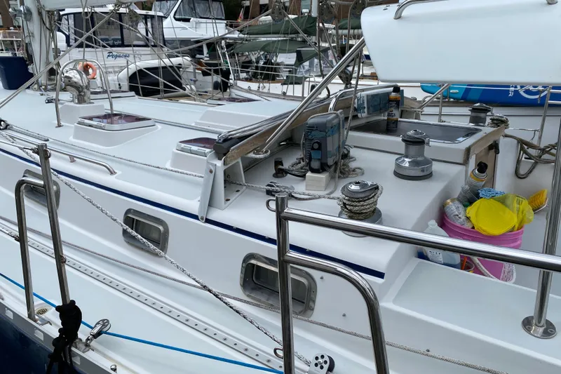 Slide: The Image of 2007 Valiant 50 sailboat deck with hatches and rigging in marina setting. - 12