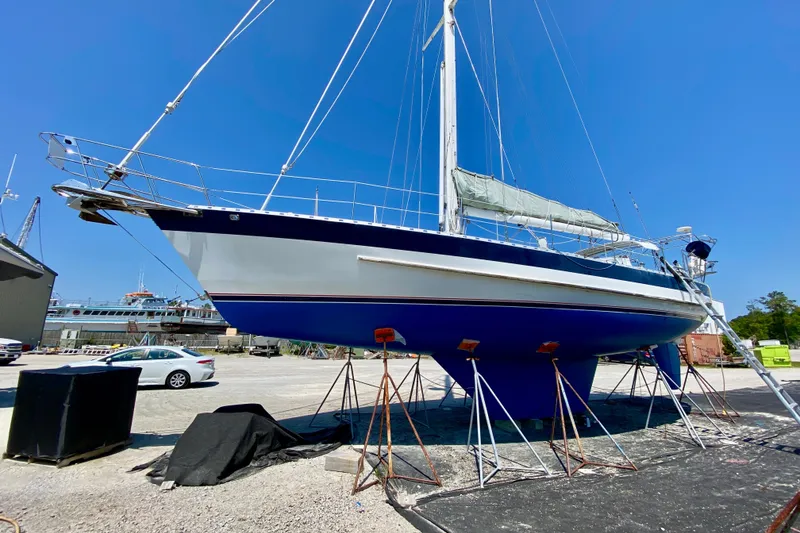Slide: The Image of Sailboat Valiant 50, 2007 model, on dry dock under clear blue sky. - 1